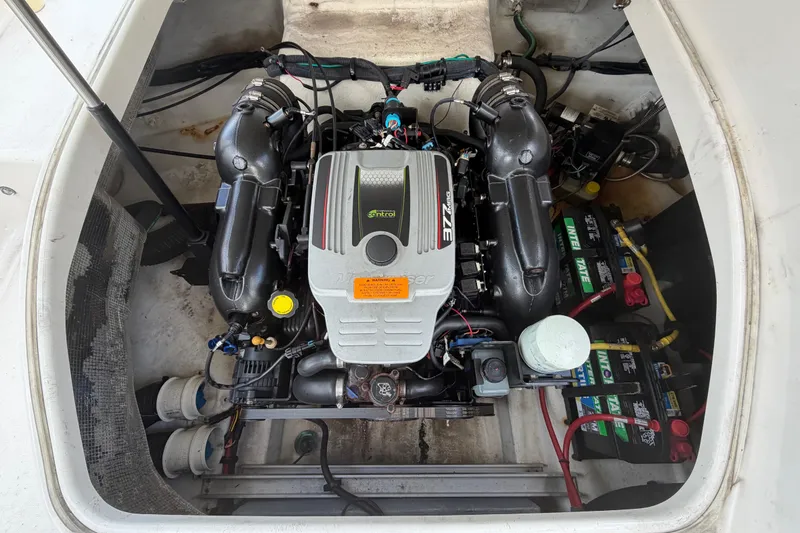 Slide: The Image of Engine compartment of 2015 Chaparrall 264 Sunesta boat, featuring a powerful motor and batteries. - 26