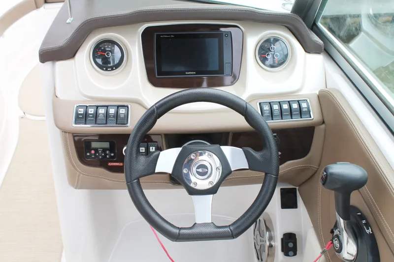 Slide: The Image of 2015 Chaparral Sunesta 264 dashboard with steering wheel, controls, and Garmin display. - 26