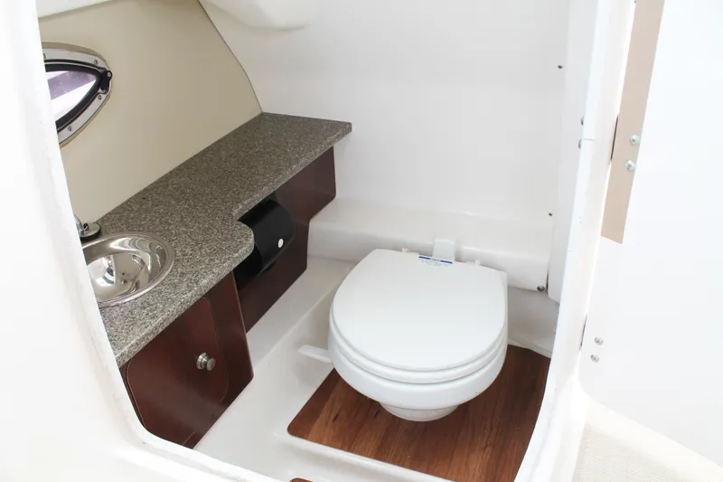 Slide: The Image of 2015 Chaparral Sunesta 264 boat bathroom with sink, toilet, and countertop. - 27