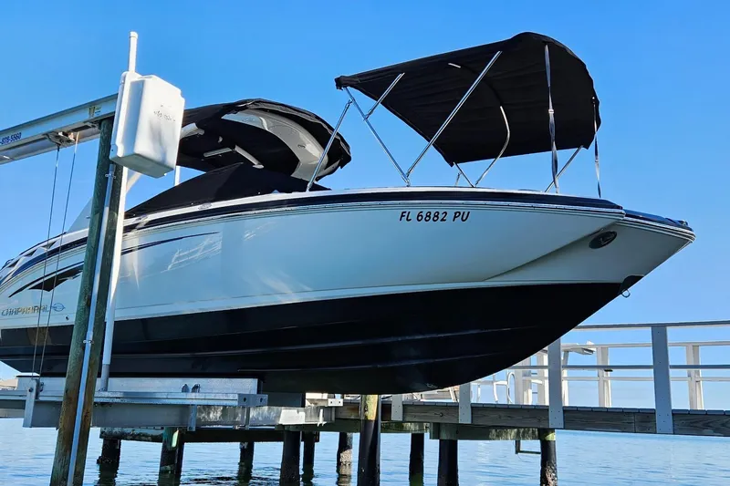 Slide: The Image of 2015 Chaparrall 264 Sunesta boat on lift, blue sky background. - 5