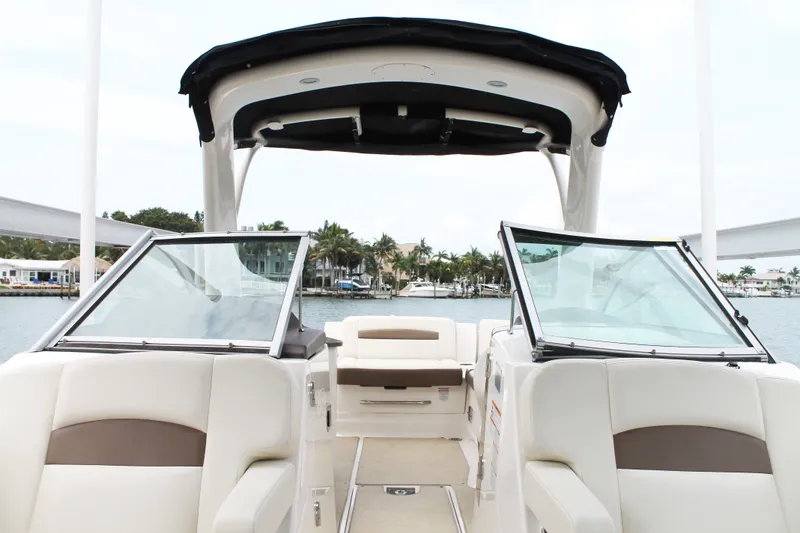 Slide: The Image of 2015 Chaparral Sunesta 264 boat interior with open deck and waterfront view. - 33