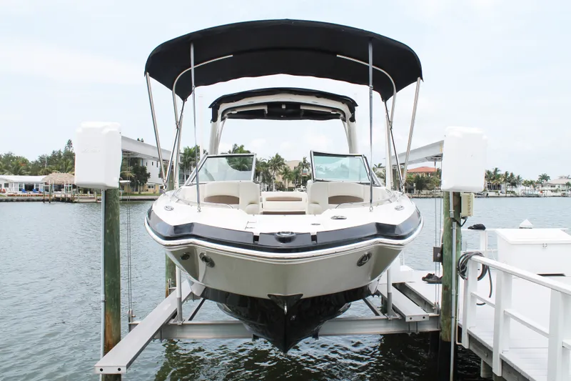 Slide: The Image of 2015 Chaparral Sunesta 264 boat docked on a lift by the waterfront. - 31