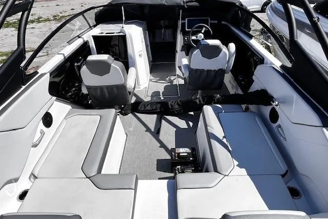 Slide: The Image of 2024 Yamaha Boats AR250 interior with modern seating and steering wheel. - 13