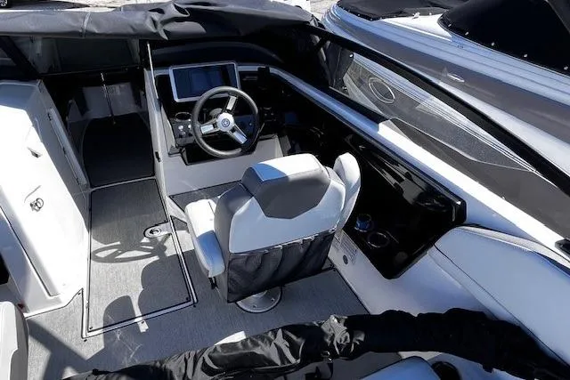Slide: The Image of 2024 Yamaha Boats AR250 cockpit with steering wheel, dashboard, and seating. - 15