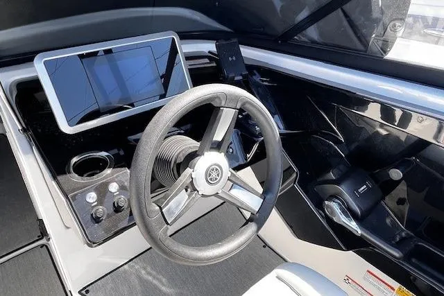 Slide: The Image of 2024 Yamaha Boats AR250 helm with steering wheel, touchscreen display, and controls. - 16