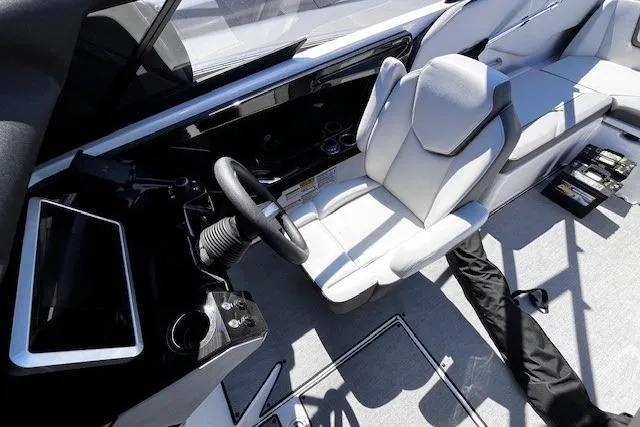Slide: The Image of 2024 Yamaha Boats AR250 cockpit with modern steering and seating. - 18