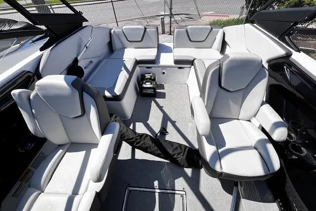 Slide: The Image of 2024 Yamaha Boats AR250 interior with spacious seating and modern design. - 19