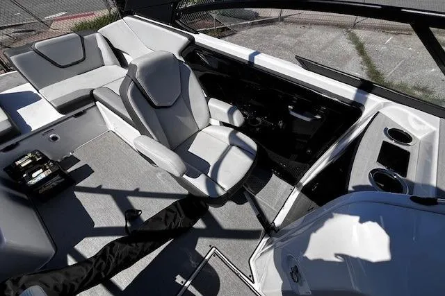 Slide: The Image of 2024 Yamaha Boats AR250 interior with sleek seating and modern dashboard design. - 20