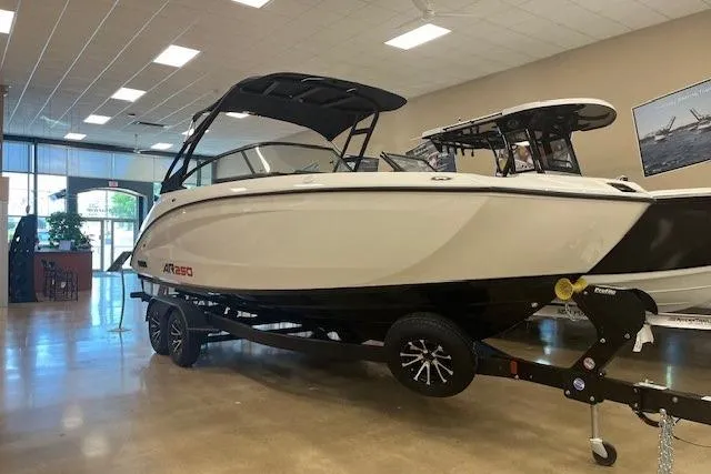Slide: The Image of 2024 Yamaha Boats AR250 displayed indoors on a trailer. - 6