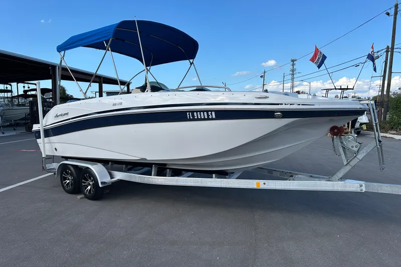 The Image of 2018 Hurricane Sundeck Sport 218 OB boat on trailer with blue canopy. - 1