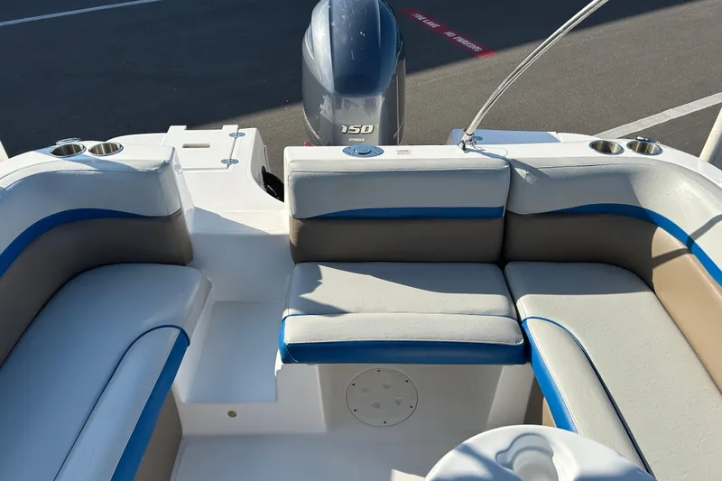 Slide: The Image of 2018 Hurricane Sundeck Sport 218 OB boat interior with seating and outboard motor. - 13