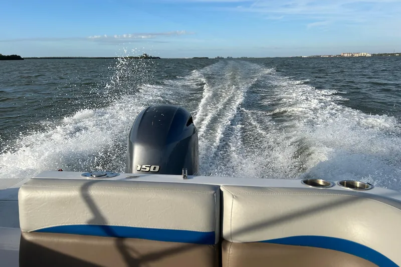 Slide: The Image of 2018 Hurricane Sundeck Sport 218 OB cruising on open water, leaving a wake behind. - 19