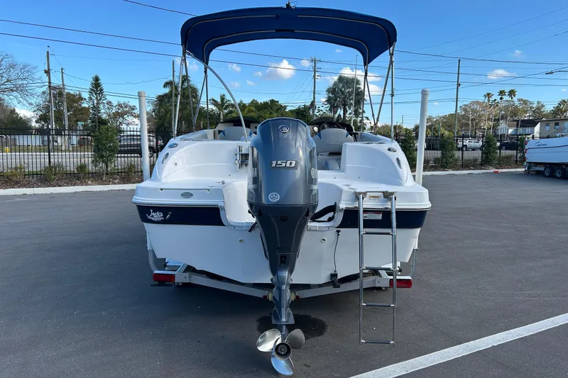 Slide: The Image of 2018 Hurricane Sundeck Sport 218 OB boat with Yamaha 150 engine, parked outdoors. - 3