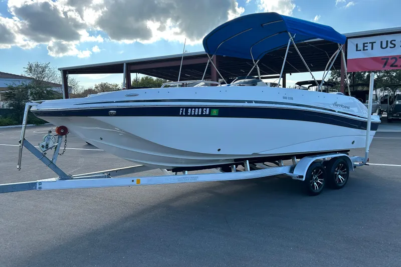 Slide: The Image of 2018 Hurricane Sundeck Sport 218 OB boat on trailer with blue canopy. - 5