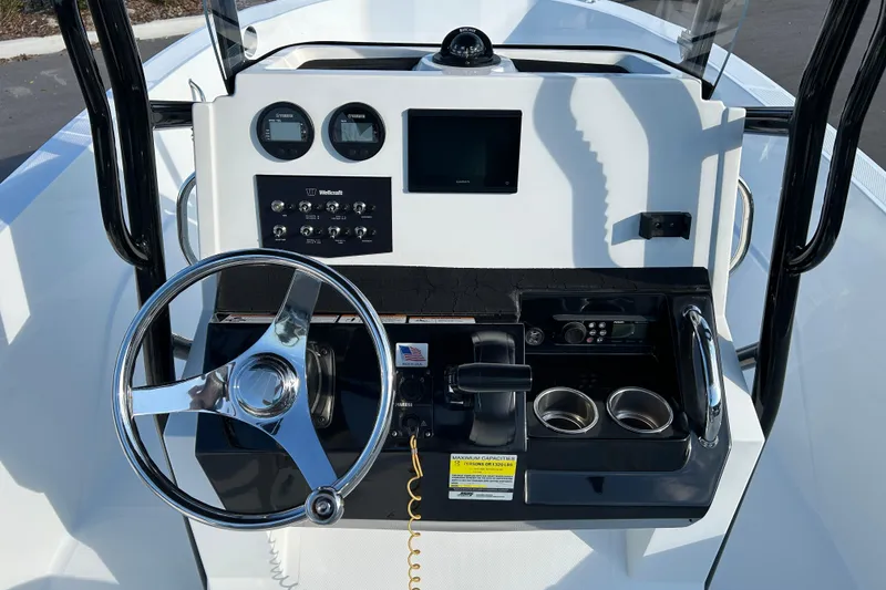 Slide: The Image of Center console of 2022 Wellcraft 202 Fisherman boat with steering wheel and controls. - 11