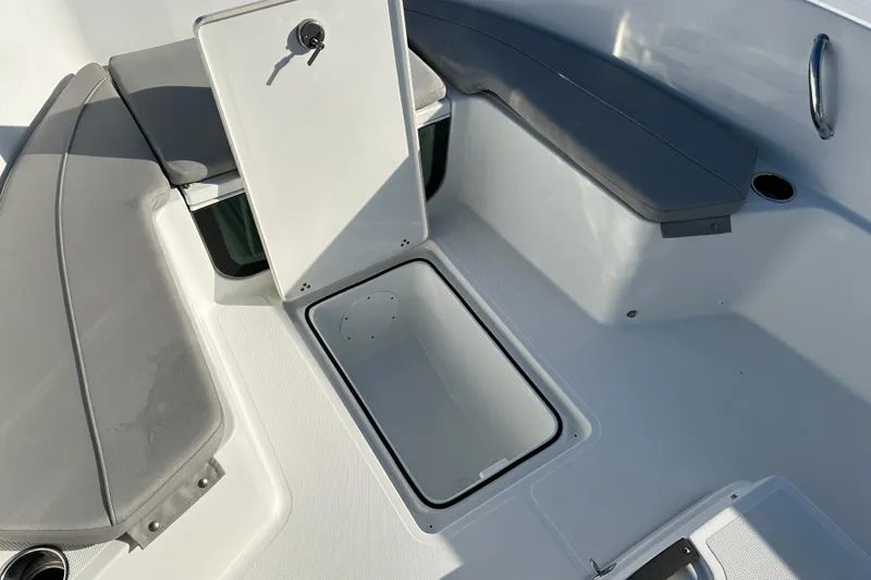 Slide: The Image of 2022 Wellcraft 202 Fisherman boat interior with open storage compartment and seating. - 15