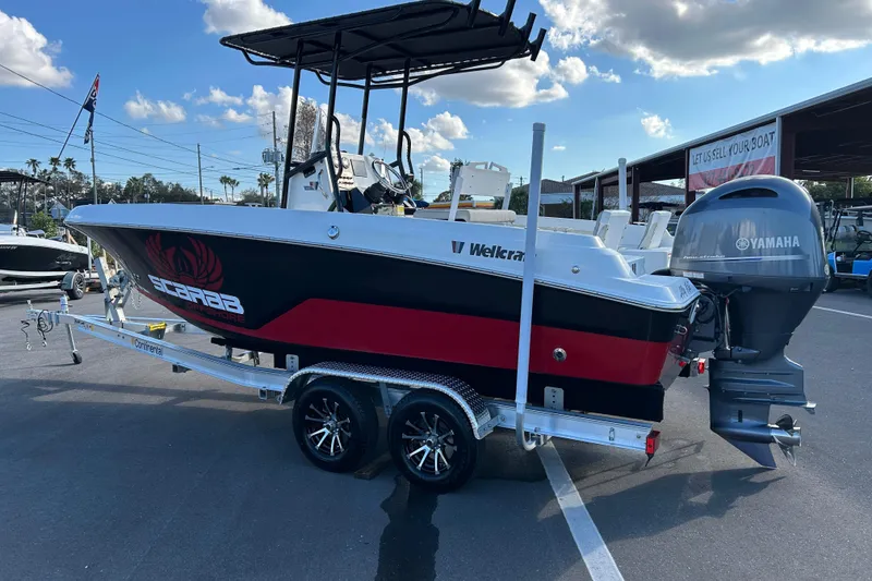Slide: The Image of 2022 Wellcraft 202 Fisherman boat on trailer with Yamaha engine, parked outdoors. - 4