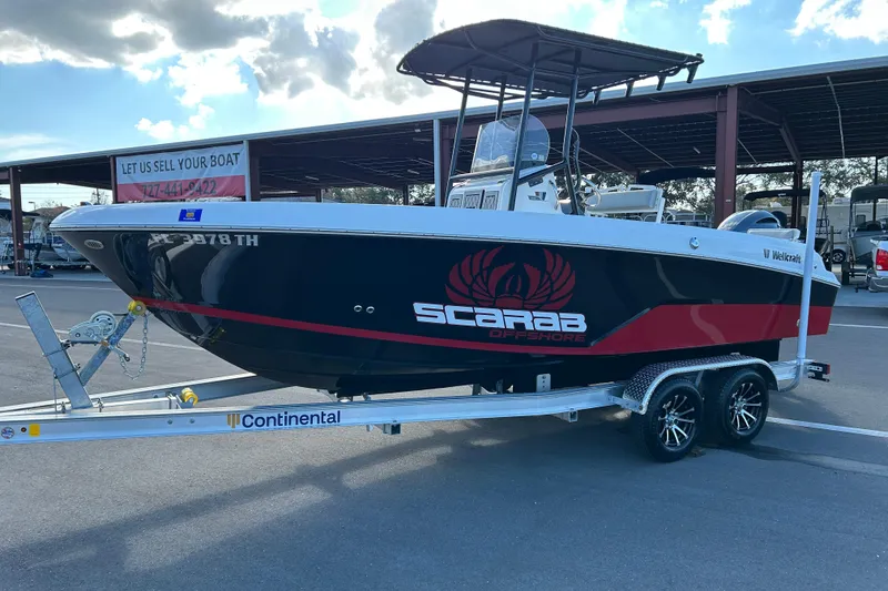 Slide: The Image of 2022 Wellcraft 202 Fisherman boat on trailer, displayed outdoors under a cloudy sky. - 5