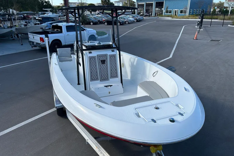 Slide: The Image of 2022 Wellcraft 202 Fisherman boat in parking lot, showcasing sleek design and spacious interior. - 6