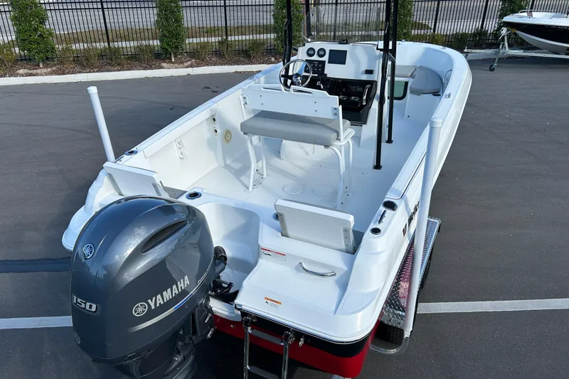 Slide: The Image of 2022 Wellcraft 202 Fisherman boat with Yamaha engine, parked on pavement. - 7