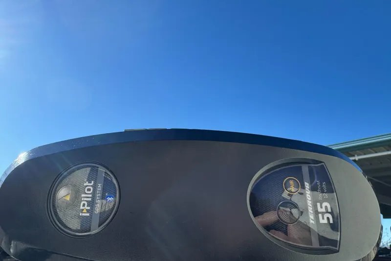 Slide: The Image of Trolling motor control panel on 2010 Alumacraft Fisherman 145 CS under clear blue sky. - 4