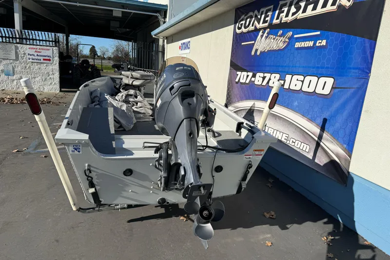 Slide: The Image of 2010 Alumacraft Fisherman 145 CS boat with Yamaha outboard motor at dealership. - 5