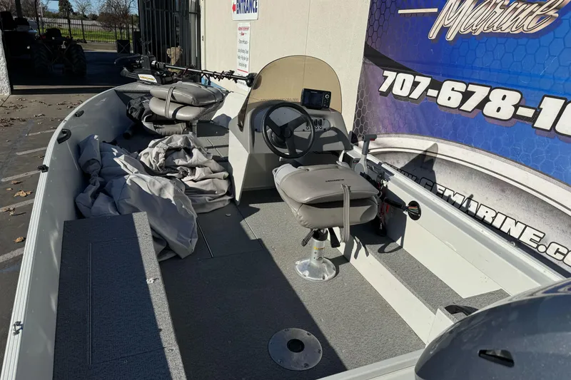 Slide: The Image of 2010 Alumacraft Fisherman 145 CS boat interior with seats and steering console. - 7