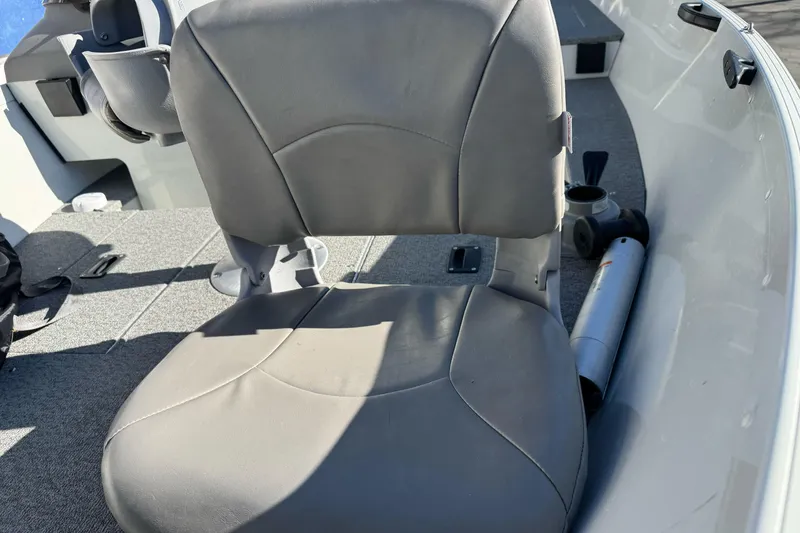 Slide: The Image of 2010 Alumacraft Fisherman 145 CS boat interior with gray seating and carpeted flooring. - 8