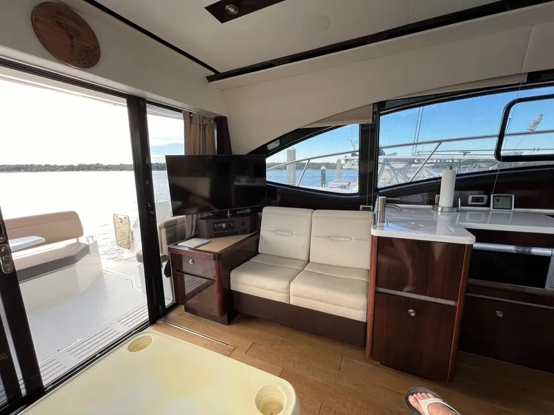 Slide: The Image of Interior of a 2017 Sea Ray Sundancer 400 yacht with sofa and TV. - 16