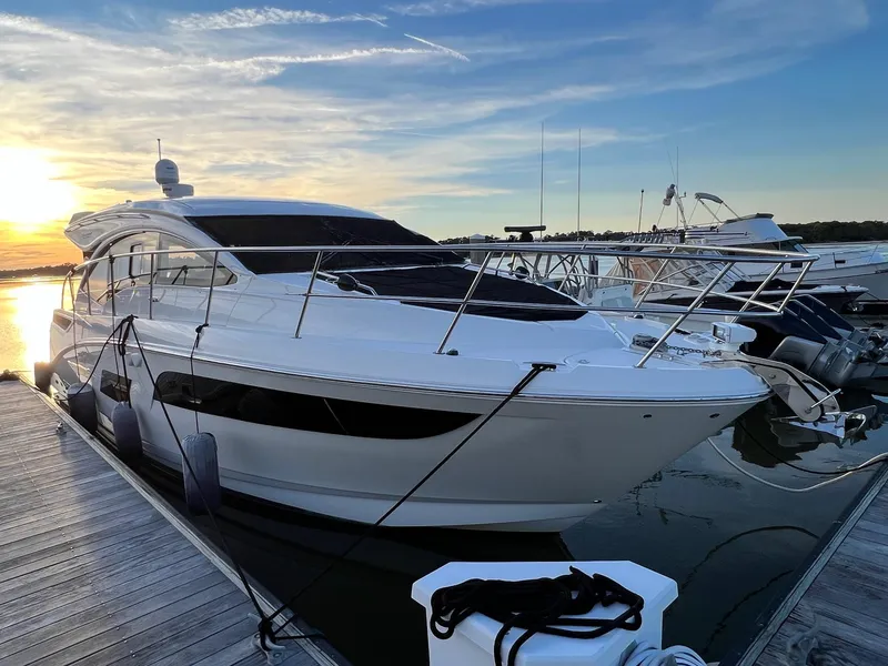 Slide: The Image of 2017 Sea Ray Sundancer 400 yacht docked at sunset. - 2
