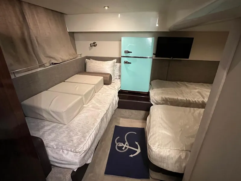 Slide: The Image of Twin beds in the 2017 Sea Ray Sundancer 400 cabin, featuring modern design and cozy lighting. - 42