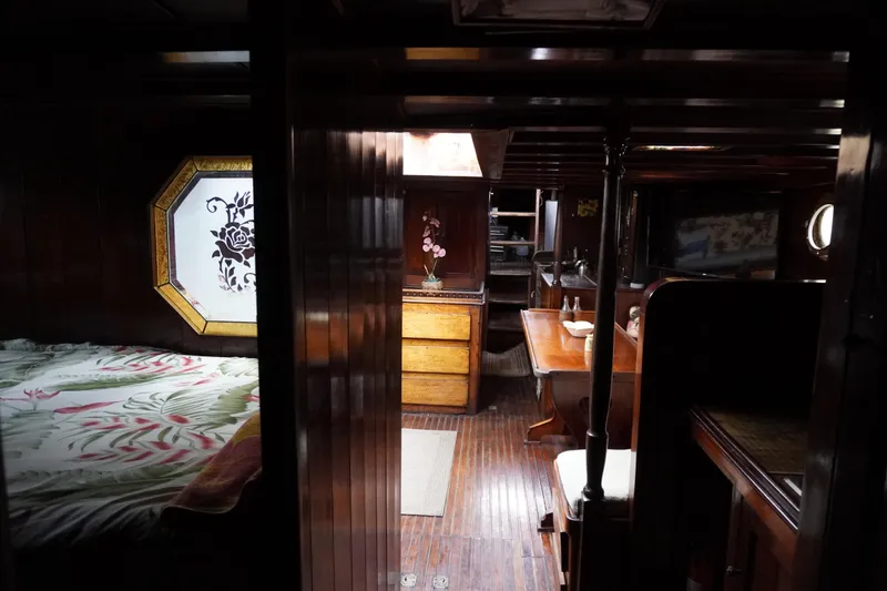 Slide: The Image of Interior of a 1976 Manila Shipbuilders sailboat with wooden furnishings and cozy decor. - 10
