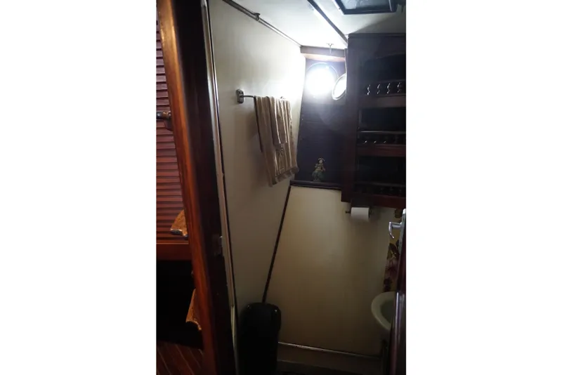 Slide: The Image of 1976 Manila Shipbuilders sailboat interior bathroom with towel rack and shelves. - 18