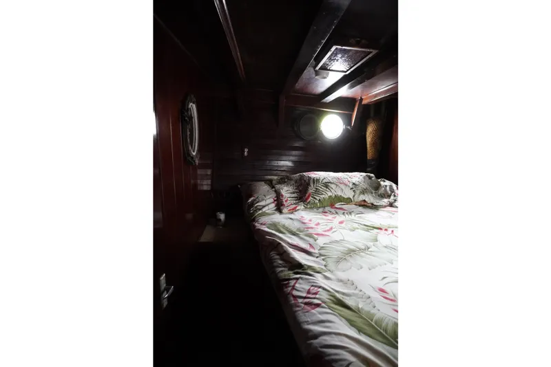 Slide: The Image of Cozy cabin interior of 1976 Manila Shipbuilders sailboat with floral bedding and porthole window. - 20