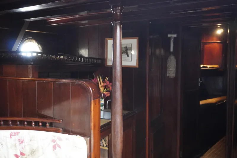 Slide: The Image of Interior of a 1976 Manila Shipbuilders sailboat with wooden paneling and cozy decor. - 21