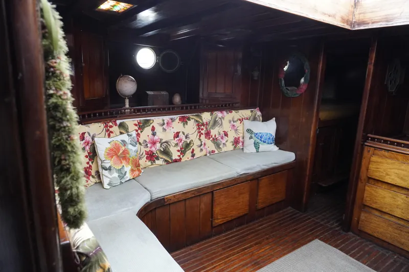 Slide: The Image of Cozy 1976 Manila Shipbuilders sailboat interior with floral cushions and wooden decor. - 24