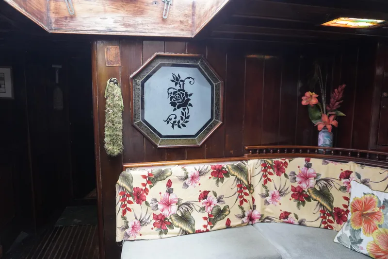 Slide: The Image of Cozy 1976 Manila Shipbuilders sailboat interior with floral upholstery and wooden paneling. - 27