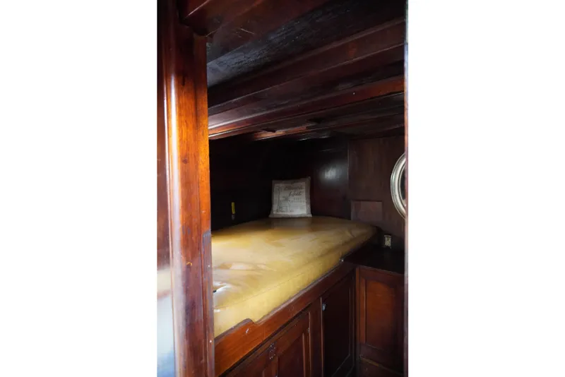Slide: The Image of Cozy wooden cabin interior of 1976 Manila Shipbuilders sailboat with a cushioned bed. - 28