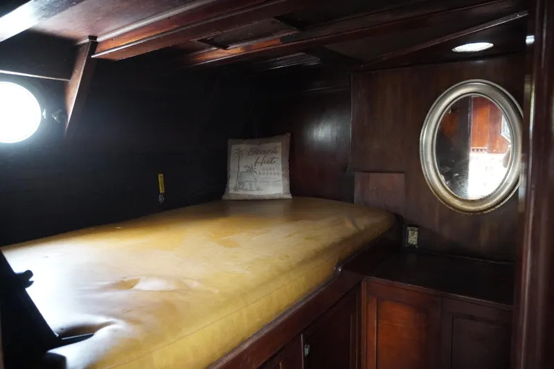 Slide: The Image of 1976 Manila Shipbuilders sailboat cabin with wooden interior and oval porthole. - 29