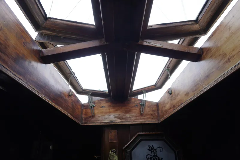 Slide: The Image of Interior view of a 1976 Manila Shipbuilders sailboat with wooden hatch details. - 31