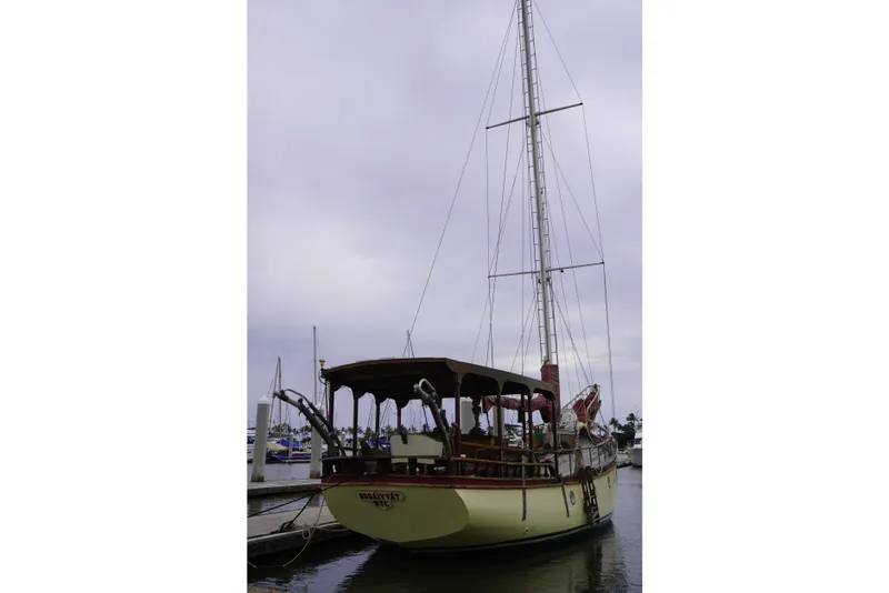 Slide: The Image of Vintage 1976 Manila Shipbuilders sailboat docked under cloudy skies. - 4