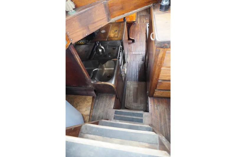 Slide: The Image of Interior of 1976 Manila Shipbuilders sailboat with wooden cabinetry and compact kitchen area. - 40