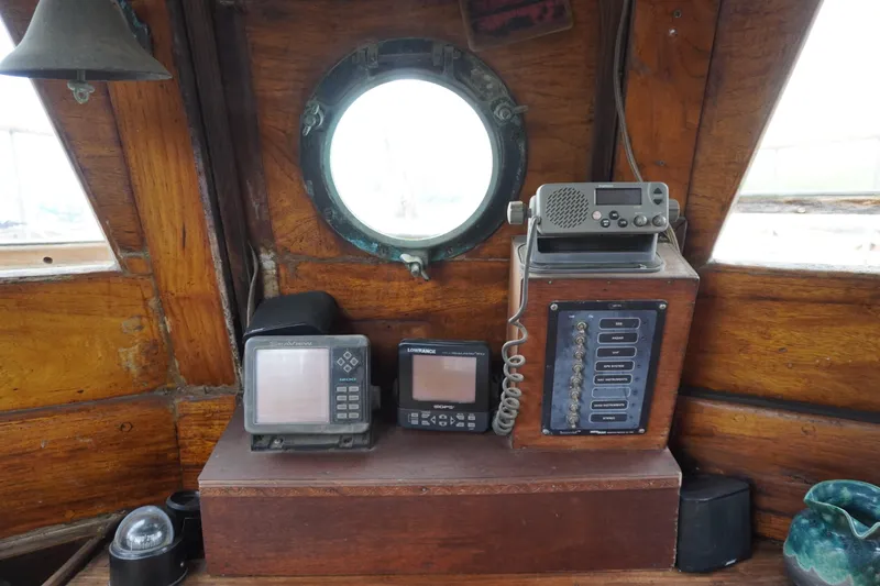 Slide: The Image of 1976 Manila Shipbuilders sailboat cockpit with vintage navigation equipment and radio. - 42