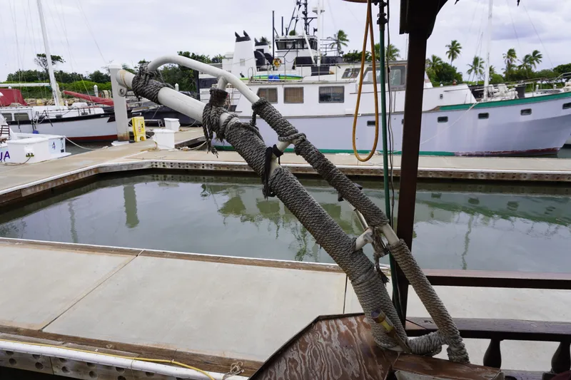 Slide: The Image of 1976 Manila Shipbuilders sailboat docked at marina with ropes and equipment visible. - 45