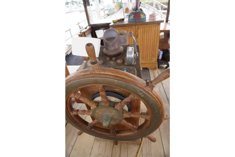 Slide: The Image of Wooden steering wheel of a 1976 Manila Shipbuilders sailboat, showcasing vintage nautical craftsmanship. - 46