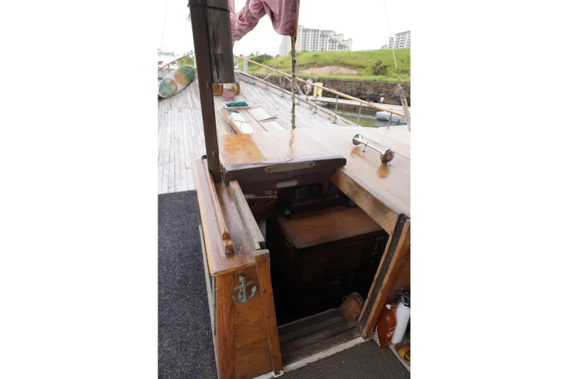 Slide: The Image of 1976 Manila Shipbuilders sailboat deck with open cabin entrance, showcasing wooden craftsmanship. - 47
