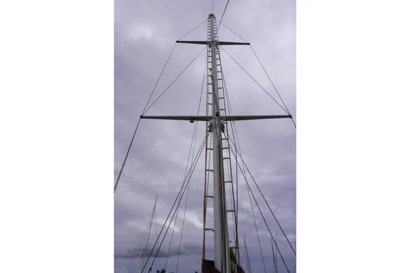 Slide: The Image of Tall sailboat mast against cloudy sky, Manila Shipbuilders 1976 model. - 52
