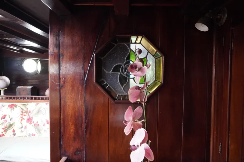 Slide: The Image of Interior of 1976 Manila Shipbuilders sailboat with stained glass window and pink orchid. - 54