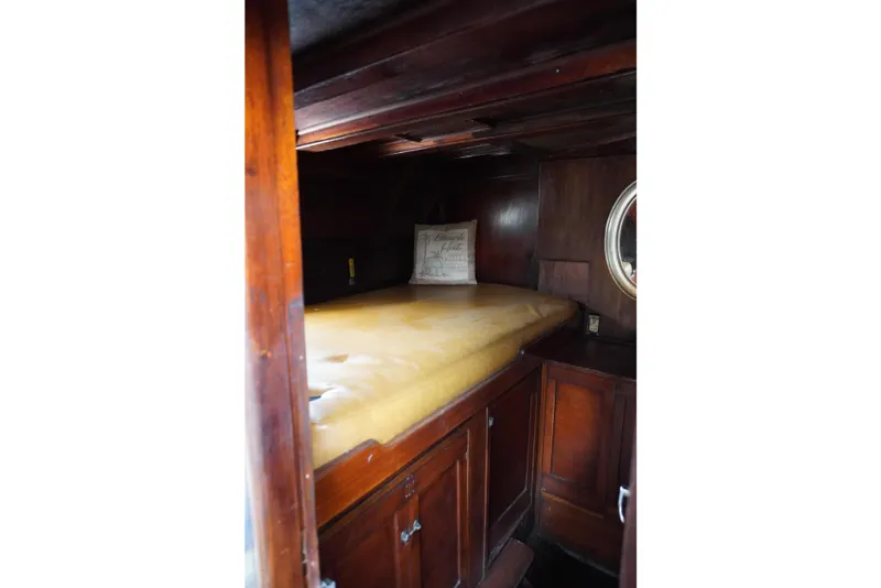 Slide: The Image of Cozy wooden cabin interior of 1976 Manila Shipbuilders sailboat with bed and porthole. - 57
