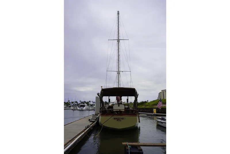 Slide: The Image of 1976 Manila Shipbuilders sailboat docked at marina under cloudy sky. - 58
